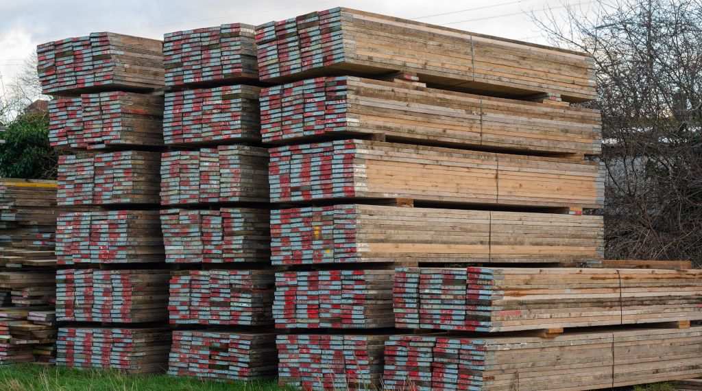 Scaffold boards stacked in rows